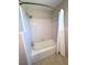 Retro bathroom with pink tile, a window for natural light, and standard fixtures at 135 E Columbia St, Lake Alfred, FL 33850