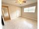 Bedroom featuring a ceiling fan, window, and closet for ample storage space at 135 E Columbia St, Lake Alfred, FL 33850