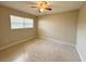 Bright bedroom featuring a ceiling fan and window, providing ample natural light at 135 E Columbia St, Lake Alfred, FL 33850