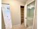 Bright bedroom with ceiling fan, neutral walls, and closet/storage space at 135 E Columbia St, Lake Alfred, FL 33850