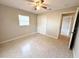 Bedroom featuring a ceiling fan, closet and a window providing natural light at 135 E Columbia St, Lake Alfred, FL 33850