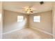 Bedroom featuring natural light, ceiling fan, and neutral decor with versatile design possibilities at 135 E Columbia St, Lake Alfred, FL 33850