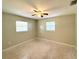 Bedroom featuring natural light, ceiling fan, and neutral decor with versatile design possibilities at 135 E Columbia St, Lake Alfred, FL 33850