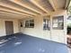 Attached carport with concrete floor and tan home exterior at 135 E Columbia St, Lake Alfred, FL 33850