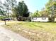 Exterior front view of a one story home with front yard at 135 E Columbia St, Lake Alfred, FL 33850