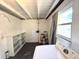 Laundry room in need of updating with washer, dryer and shelving at 135 E Columbia St, Lake Alfred, FL 33850