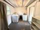 Spacious laundry room with washer, dryer, shelving and storage at 135 E Columbia St, Lake Alfred, FL 33850
