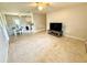 Bright living room with terrazzo flooring leading to the dining area and kitchen at 135 E Columbia St, Lake Alfred, FL 33850