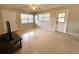 Minimalist living room with natural light, two windows, and two entry doors at 135 E Columbia St, Lake Alfred, FL 33850