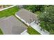 Aerial view highlighting home's facade, driveway, and surrounding trees, offering a serene setting at 1415 S Lincoln Ave, Lakeland, FL 33803