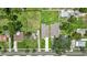 An aerial view showcasing two houses, with green lawns, driveways, and street view at 1415 S Lincoln Ave, Lakeland, FL 33803