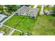 A bird's-eye view showcases two homes with fenced yards, perfect for outdoor activities at 1415 S Lincoln Ave, Lakeland, FL 33803