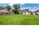 Expansive backyard featuring a lush green lawn and mature trees, perfect for outdoor activities at 1415 S Lincoln Ave, Lakeland, FL 33803