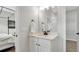 Bright bathroom featuring a white vanity with black hardware and a large mirror at 1415 S Lincoln Ave, Lakeland, FL 33803