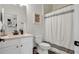 Bathroom featuring neutral tones, a shower with a shower curtain and a single sink vanity at 1415 S Lincoln Ave, Lakeland, FL 33803