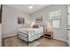 Bright bedroom featuring wood floors, a black metal bed frame, and a patterned area rug at 1415 S Lincoln Ave, Lakeland, FL 33803