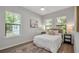 Sunlit bedroom with neutral tones, three windows and hardwood floors, creating a calming atmosphere at 1415 S Lincoln Ave, Lakeland, FL 33803