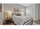 Bright bedroom featuring wood floors, a black metal bed frame, and natural wood bedside table at 1415 S Lincoln Ave, Lakeland, FL 33803