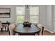Elegant dining area featuring a dark wood table and chair set, enhanced by bright natural light at 1415 S Lincoln Ave, Lakeland, FL 33803
