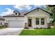 Beautiful exterior of a home with a well-maintained lawn, charming entrance and attached two-car garage at 1415 S Lincoln Ave, Lakeland, FL 33803