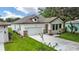 Charming home boasting a white exterior, attached garage, and well-manicured lawn at 1415 S Lincoln Ave, Lakeland, FL 33803
