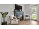 Close up of a decorative fireplace with comfortable chairs nearby at 1415 S Lincoln Ave, Lakeland, FL 33803
