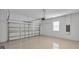 Spacious two car garage with a smooth epoxy floor, offering ample room for vehicles and storage at 1415 S Lincoln Ave, Lakeland, FL 33803