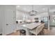 Charming kitchen features white cabinetry, stainless steel appliances, and a functional center island with seating at 1415 S Lincoln Ave, Lakeland, FL 33803