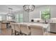 Bright kitchen showcasing a large island with seating, modern lighting, and stainless steel appliances at 1415 S Lincoln Ave, Lakeland, FL 33803