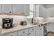 Close-up of a well-equipped kitchen with quartz countertops, modern appliances, and sleek white cabinetry at 1415 S Lincoln Ave, Lakeland, FL 33803