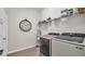 Laundry room featuring stainless steel washer and dryer units and wire shelving at 1415 S Lincoln Ave, Lakeland, FL 33803