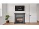 Cozy living room featuring a modern fireplace and television, perfect for relaxing evenings at 1415 S Lincoln Ave, Lakeland, FL 33803