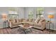 Comfortable seating area with an L-shaped sofa, stylish rug, and plenty of natural light at 1415 S Lincoln Ave, Lakeland, FL 33803