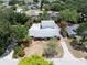Aerial view of a home with a pool, lush greenery, a neatly paved driveway, and a spacious backyard at 16 Golfview Ne Cir, Winter Haven, FL 33881