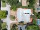 Aerial view of a single-Gathering home featuring a pool and meticulously maintained landscaping at 16 Golfview Ne Cir, Winter Haven, FL 33881