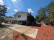 Exterior shot of a spacious backyard with a driveway, mature trees, and partial view of a pool at 16 Golfview Ne Cir, Winter Haven, FL 33881