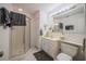 Clean bathroom featuring a glass-enclosed shower, vanity, and tiled floor at 16 Golfview Ne Cir, Winter Haven, FL 33881