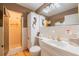 Bathroom with a walk-in shower, white cabinetry, and ample lighting at 16 Golfview Ne Cir, Winter Haven, FL 33881