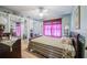 Cozy bedroom featuring a comfortable bed, ceiling fan, and mirrored closet doors at 16 Golfview Ne Cir, Winter Haven, FL 33881