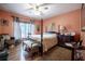 Cozy bedroom features a four-poster bed, hardwood floors, and natural light at 16 Golfview Ne Cir, Winter Haven, FL 33881