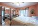 Bedroom with a closet, hardwood floors, and view of the yard at 16 Golfview Ne Cir, Winter Haven, FL 33881