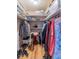 Walk-in closet with built-in shelving and hardwood floors providing ample storage at 16 Golfview Ne Cir, Winter Haven, FL 33881