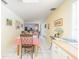 Bright dining area with white tile flooring, complemented by a table with a red and white checkered tablecloth at 16 Golfview Ne Cir, Winter Haven, FL 33881