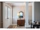 Inviting entryway featuring a decorative glass door and a charming wood chest with mirror and lamp at 16 Golfview Ne Cir, Winter Haven, FL 33881