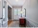 Elegant entryway with decorative double doors, complemented by hardwood flooring and a charming console table at 16 Golfview Ne Cir, Winter Haven, FL 33881