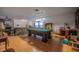 Large game room with pool table, laminate flooring, and casual seating, great for entertainment at 16 Golfview Ne Cir, Winter Haven, FL 33881