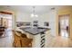 Kitchen island with a granite countertop and wine rack, perfect for entertaining guests at 16 Golfview Ne Cir, Winter Haven, FL 33881