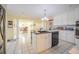 Open-concept kitchen with a view into the dining area, complete with modern appliances and ample counter space at 16 Golfview Ne Cir, Winter Haven, FL 33881