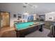 Recreational room with a pool table, hardwood floors, and access to the living room at 16 Golfview Ne Cir, Winter Haven, FL 33881