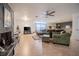 Spacious living room featuring hardwood floors, a modern ceiling fan, and a cozy fireplace at 16 Golfview Ne Cir, Winter Haven, FL 33881